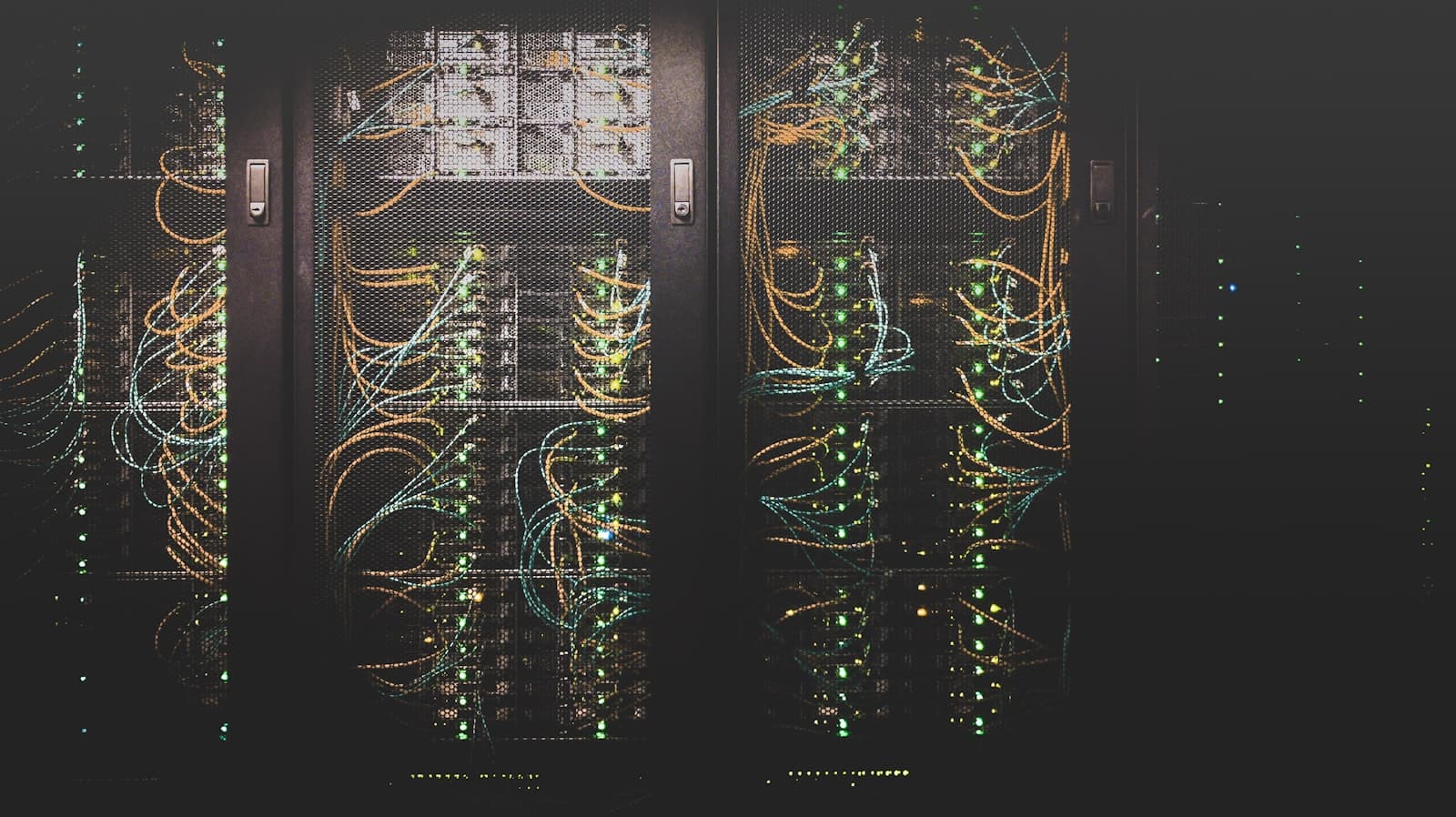 Dark server racks with status lights and cabling